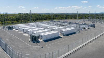 Aerial view of a utility-scale BESS location with containerised battery storage systems and grid substation