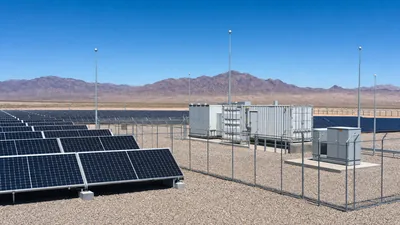 Industrial remote solar power system with ground-mounted photovoltaic panels and battery energy storage container.