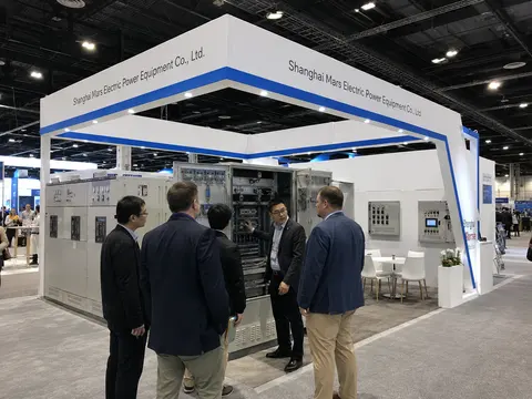 MARS engineers presenting energy storage cabinets to visitors at a renewable-energy exhibition