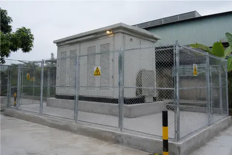 Fenced and completed compact prefabricated substation on an industrial site